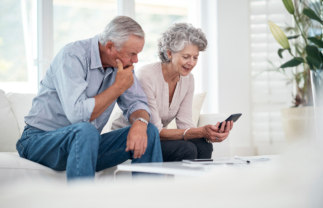 senior couple looking at a mobile phone